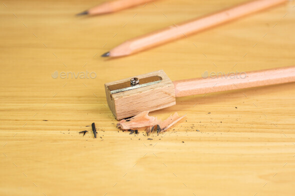 pencil and pencil sharpener on wood table