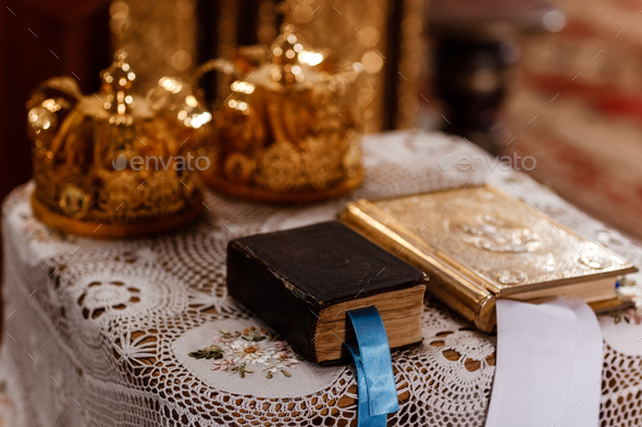 wedding Golden crowns and bible on the table in church. Wedding crowns in church ready for marriage