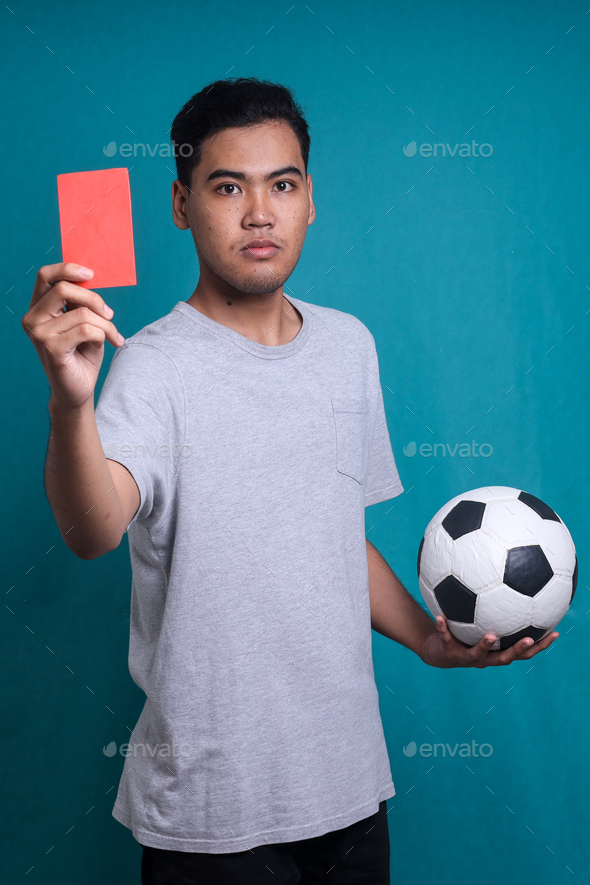 Asian referee showing red penalty card