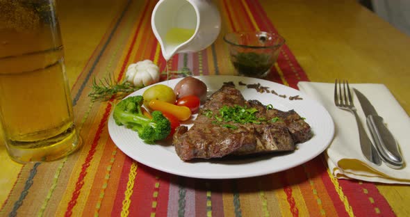 Steak Dinner And Oil Being Poured On Vegetables 51b