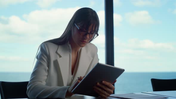 Office Intern Using Tablet at Panorama Window alt