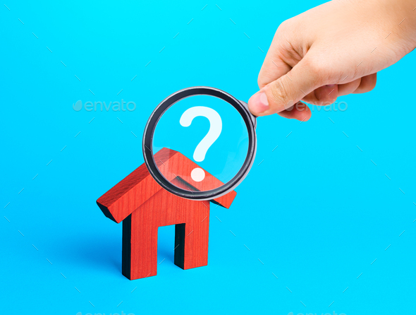 Realtor examines houses through a magnifying glass. Real estate market review.
