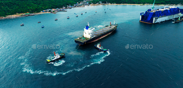 Tug boat drag pull cargo container ship from dry dock concept maintenance service working in the sea