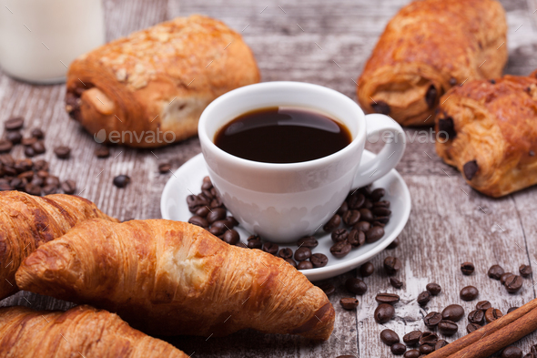 Cup of Coffee with Pastry on rustic wood table background Stock Photo