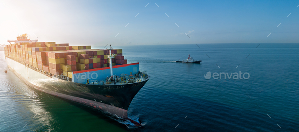 Aerial side view of cargo ship carrying container and running for export goods from cargo yard