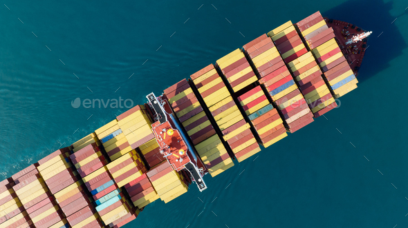 Aerial top view of cargo ship carrying container and running for export goods from cargo yard