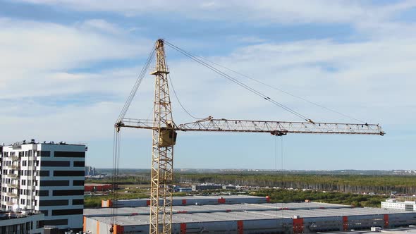 Tower Crane Stands on Construction Site of Residential Area alt