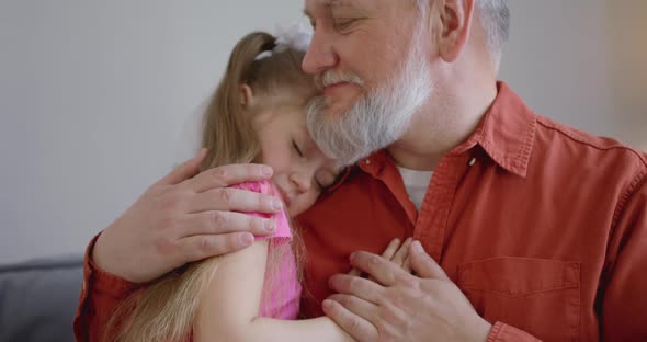 Close Up Portrait of a Father and His Daughter Who Sleeps in His Arms