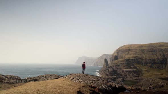 Man Overlooking Sea And Dramatic Landscape alt
