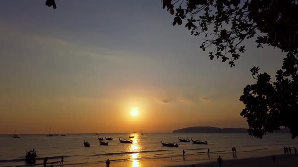 People on shore of ocean in evening alt