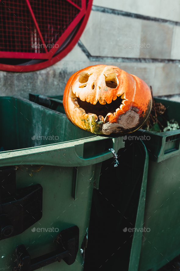 carved pumpkin with sinister smile abandoned