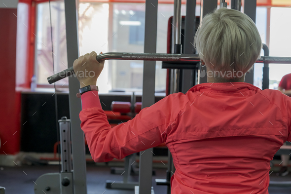 Woman doing cable lat pull-down exercise