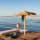 Wooden sun umbrella, sunbed and diving weights on a pier platform, Marsa Alam, Egypt. - PhotoDune Item for Sale