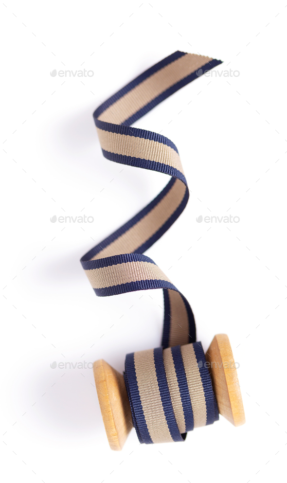 Spool with ribbon isolated on white background, top view. Sewing ribbon