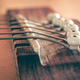 Acoustic guitar bridge and strings close up. - PhotoDune Item for Sale