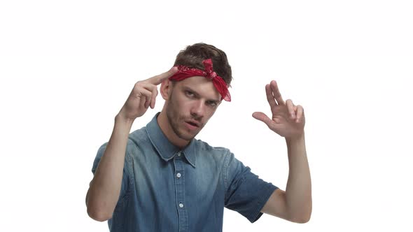 Video of Sassy Bearded Guy with Red Bandana Over Head Making Finger Guns Signs and Rapping Dancing