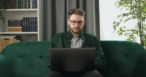 Man Working on Laptop at Home