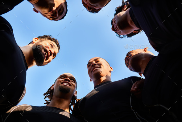 Low angle shot of a diverse group of sportsmen huddled together before playing a game of rugby