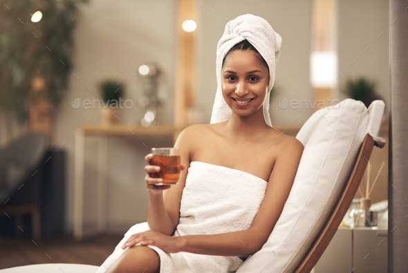 I cant imagine a better way to relax. Shot of a woman drinking tea while enjoying a spa day.