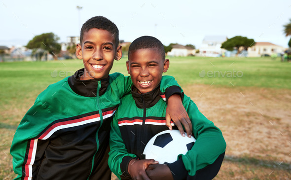 Were best buddies and teammates. Portrait of two young boys playing soccer on a sports field.