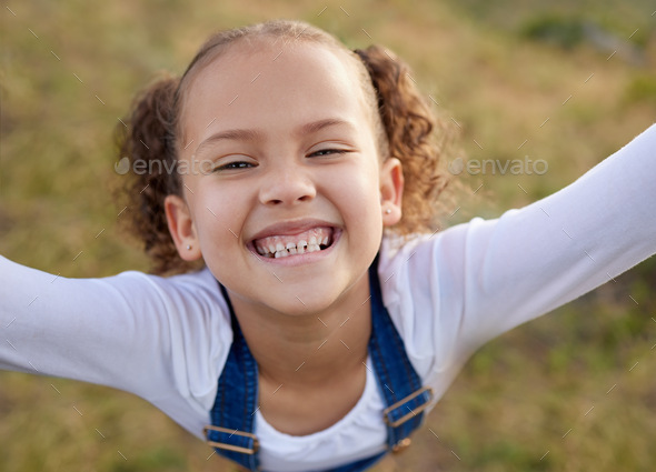 The outdoors is my happy place. Shot of an adorable little girl having fun outdoors.