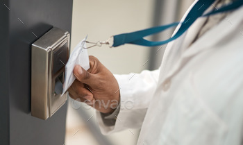 Closeup shot of an unrecognisable scientist using an access card to gain entry at a door
