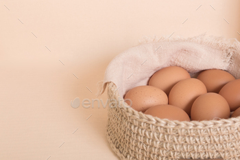 Chicken eggs in a basket. Healthy food concept, food background with copy space.