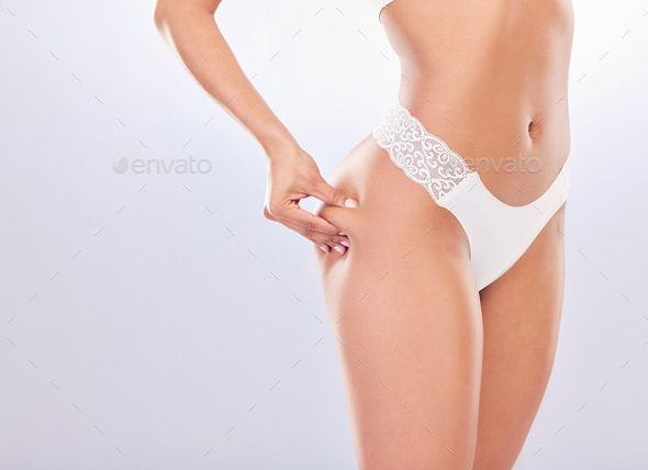 Cropped Shot Of An Unrecognisable Woman Standing Alone In The Studio And Posing In Her Underwear