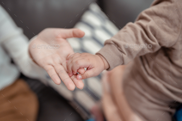Hands holding of mother parent soft touch newborn baby fingers love family concept. Infant child por