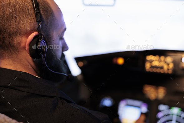 Male pilot using airplane cockpit command to fly jet
