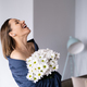Happy laughing woman holding a bouquet of white flowers - PhotoDune Item for Sale