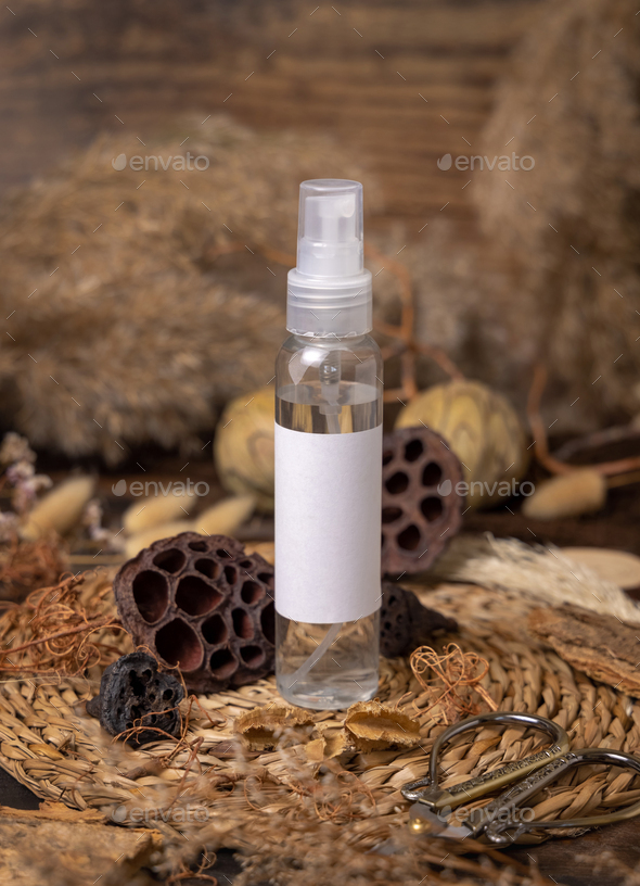 Cosmetic spray bottle on wood near natural boho decorations close up. Label Mockup