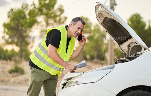 a man calling the automobile insurance company to request travel assistance for a breakdown