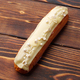 Eclairs with vanilla glaze on a wooden board - PhotoDune Item for Sale