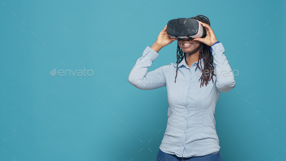 Portrait of woman using vr glasses on camera