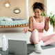 Online exercise session marathon. Happy black woman sitting on floor mat and talking with coach - PhotoDune Item for Sale
