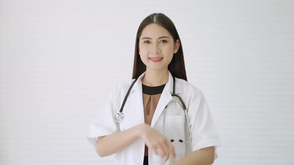 beautiful Asian female doctor standing smiling, The doctor stood confidently