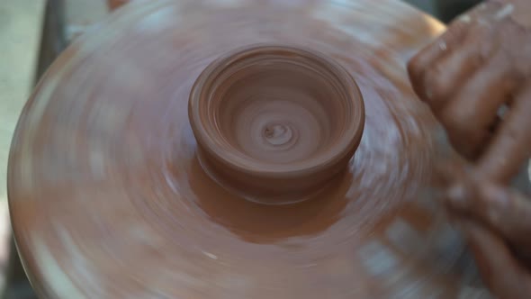 Master Potter Woman Creates a Clay Jug on an Old Potter's Wheel Twists Her Foot alt