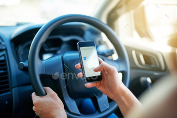 Closeup shot of a woman using a phone to find directions while driving
