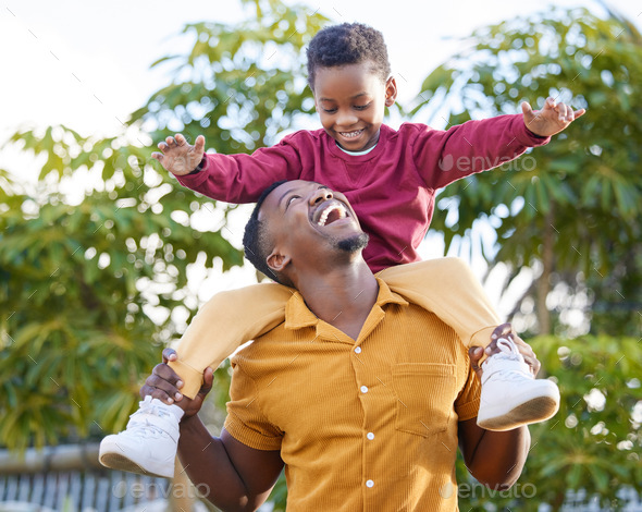 Shot of an adorable little boy enjoying a piggyback ride with his ...