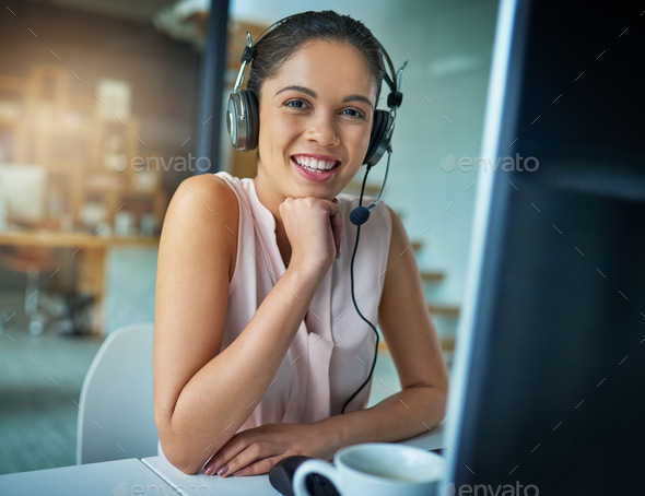 Here to help you with your queries. Shot of a young woman working in a call center.