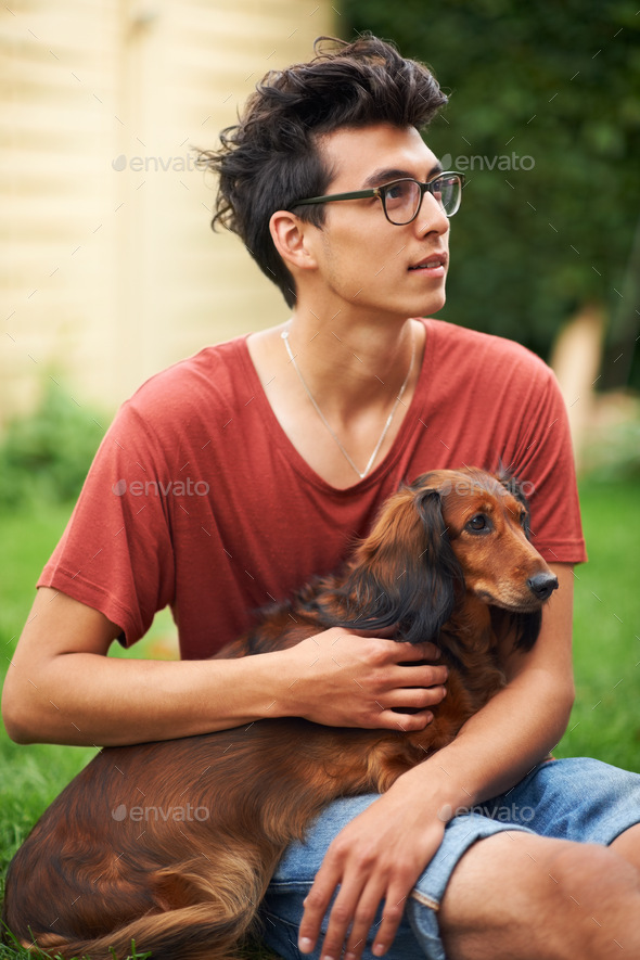 Hes my best friend. Young guy with his dog outdoors.