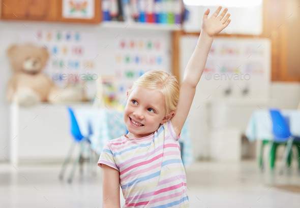Pick me. Shot of a little girl raising her hand in class.