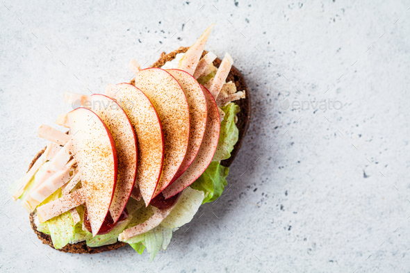 Turkey and apple sandwich, gray background. Thanksgiving leftovers concept.