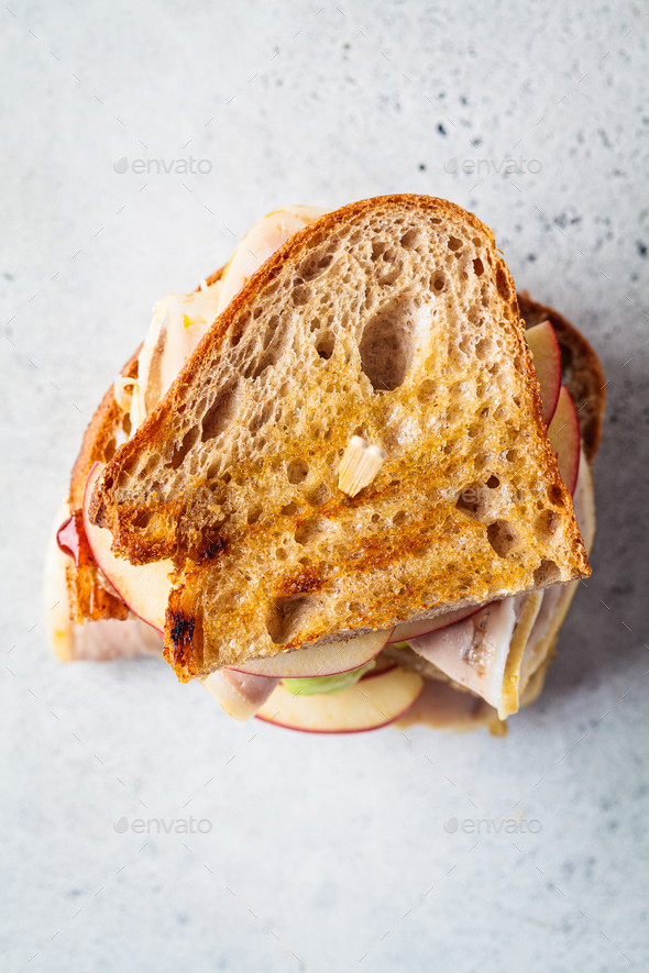 Turkey and apple sandwich, gray background. Thanksgiving leftovers concept.
