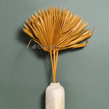 Vase with palm dry leaves