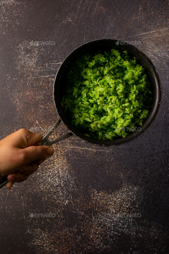 Green rice. Green dyed rice with celery and parsley. Casserole with