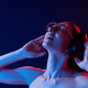 Feel the music. In headphones. Portrait of young woman that is indoors in neon lighting - PhotoDune Item for Sale