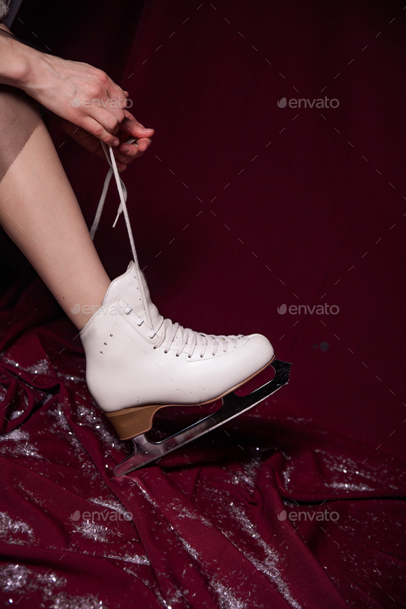 girl white ice skates red background winter - Stock Photo - Images