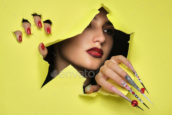 Portrait of a beautiful woman with art make up in glamorous style, creative long nails 